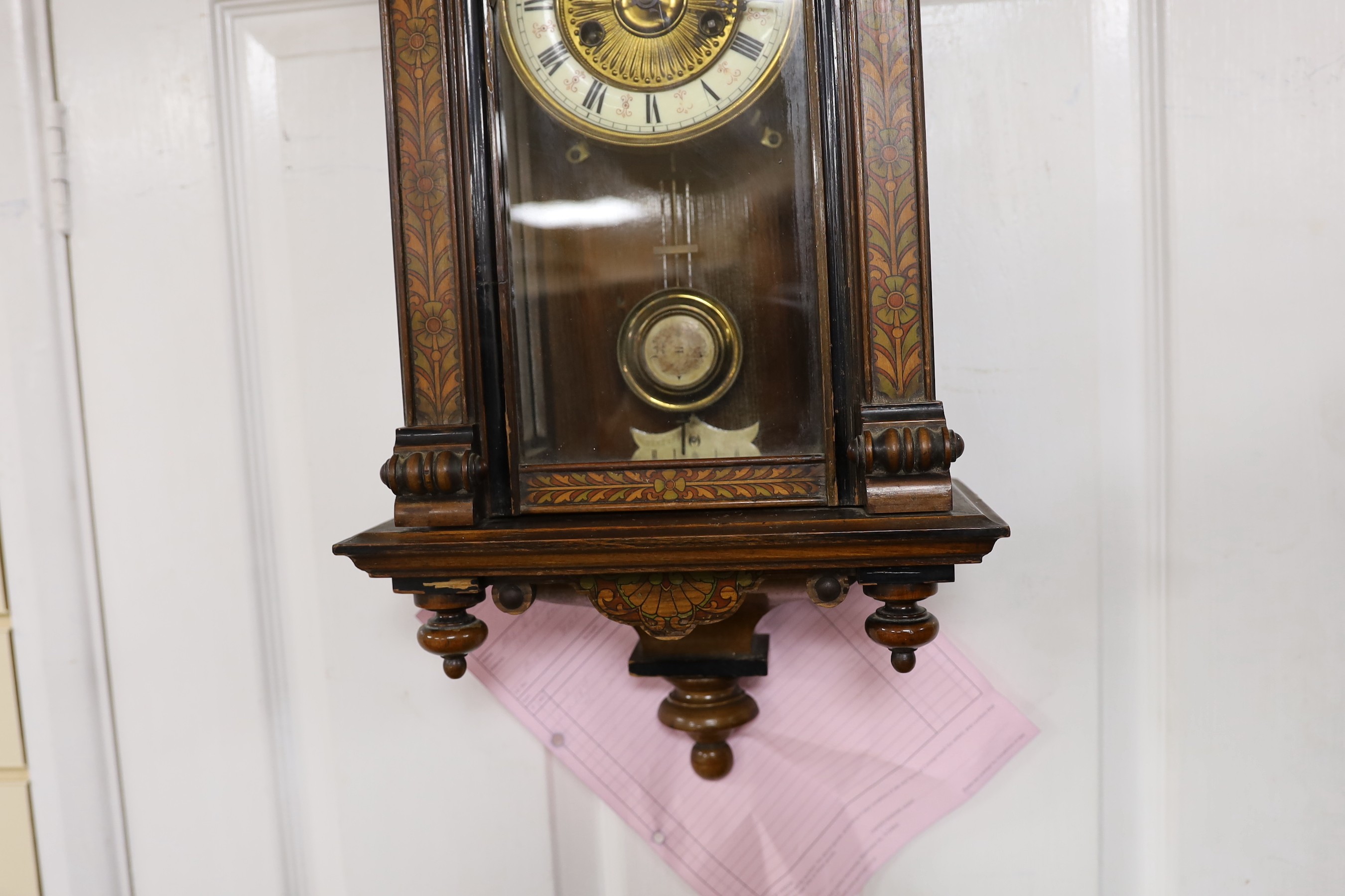 A small 19th century German wall clock with pendulum, 80cm long
